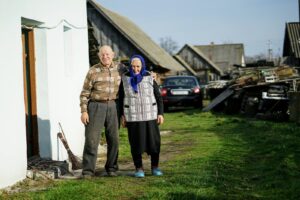 man and woman standing beside building and near cars