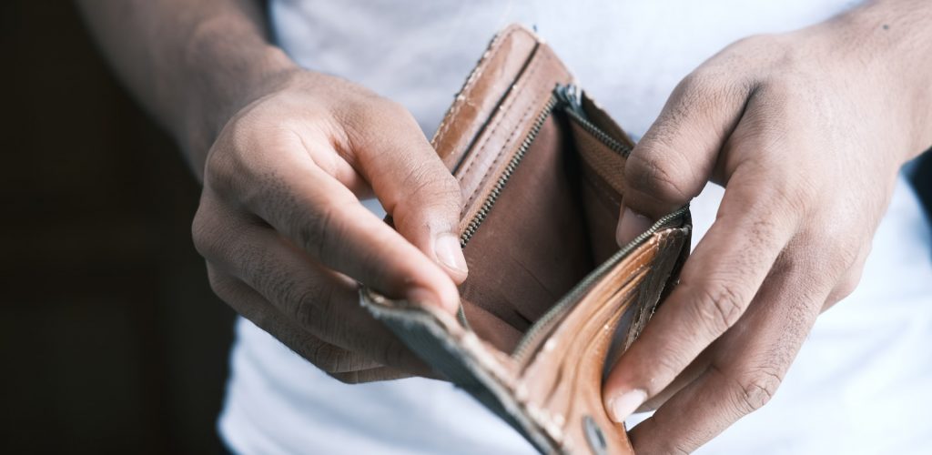 person holding brown leather bifold wallet